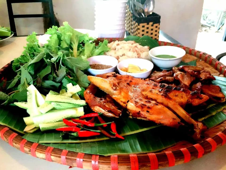 Mẹt gà nướng với rau sống, ớt và chén nước chấm